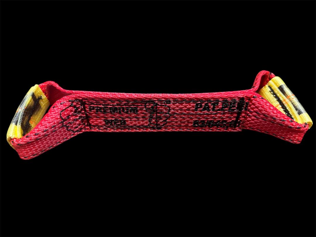 "Dog Bone" straps are featured in many tiedown systems. These straps feature reinforced eyes and abrasion resistant edged webbing.
Reinforced Eyes
Abrasion-Resistant Webbing. RED. Side view